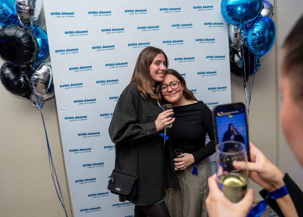 Two girls pose while someone takes their picture